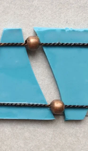 step 17 - Add the second beaded cord to the bottom of the turquoise pieces in the same way. Now is the time to align the clay with equal spacing allowing the beads to rest between pieces.