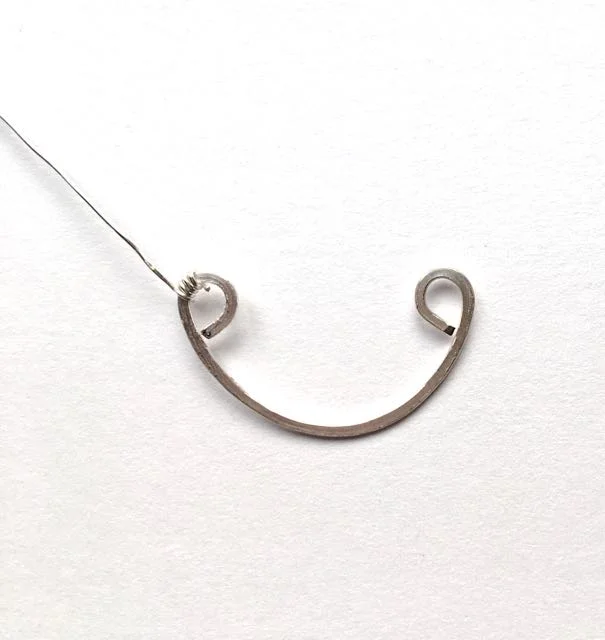 step 9 - Cut three pieces of 24 gauge wire to measure 5.50”. Wrap one end of the wire around a curl three times.