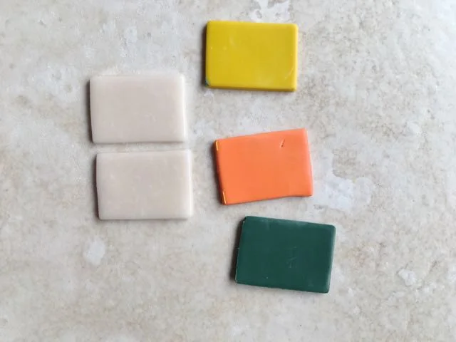 step 4 - To create the “gem” cut out a single one inch square or rectangle from yellow, orange, and green clay. Cut out two pieces of the translucent clay.