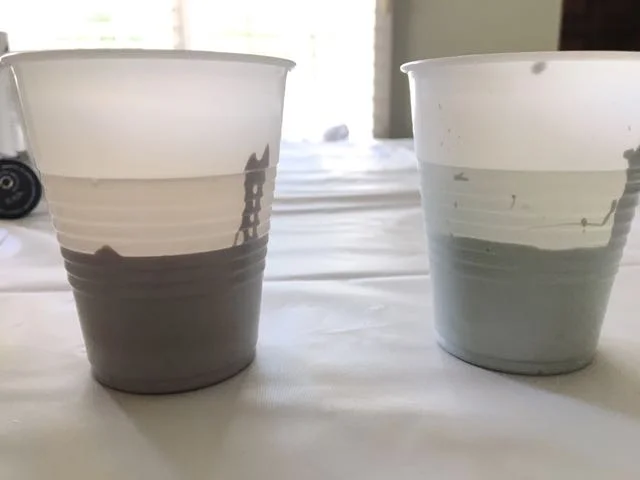 step 2 - Pour your paint colors then water into transparent plastic cups and stir thoroughly. The water sits on top of the paint allowing you to see how much of each you are using. Add three or four drops of silicone lubricant to each color to create cells in the finished art.