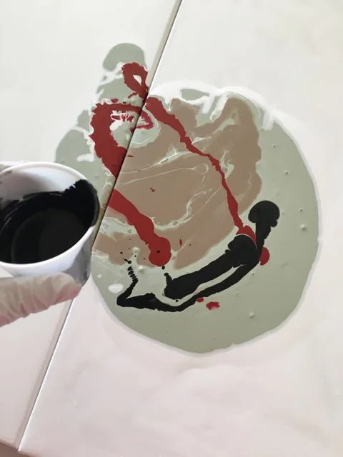 step 9 - Pour a bit of black to the right of the puddle.