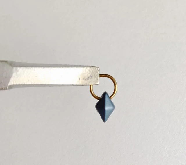 step 4 - Slide the bead so it covers the split in the ring. Create four of these bead/ring units for each earring.