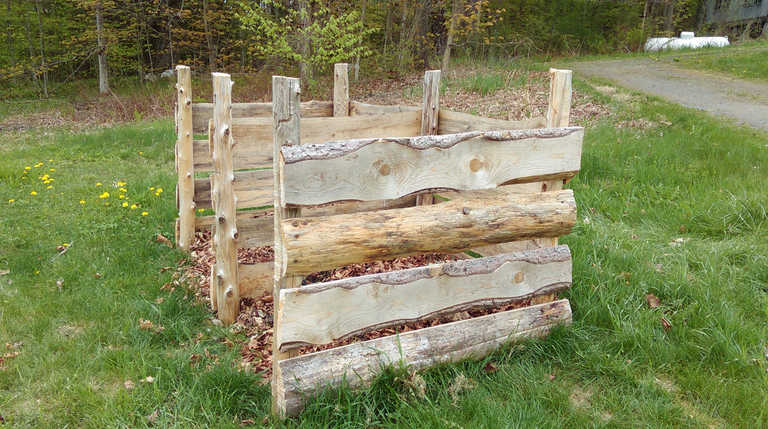 we built this compost bin out of boards we milled at our home in montague. it is similarly open to sun and rain, and the compost will cook fast! 