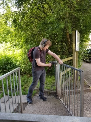 Me busy coaxing some tasty squeaks and squeals out of a metal gate.