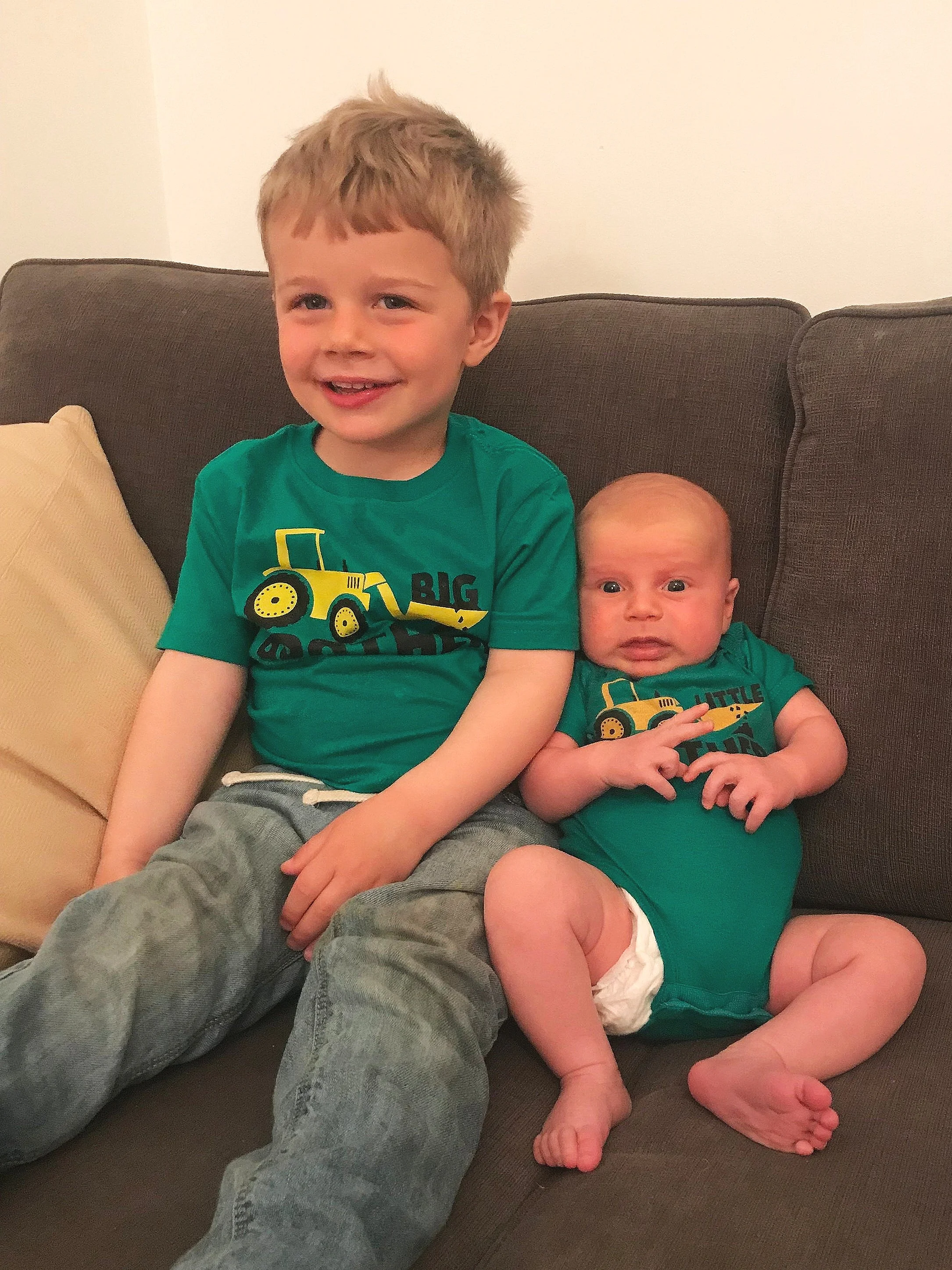 Baby Max is trying to smile and pretend he’s not totally terrified of his big brother!