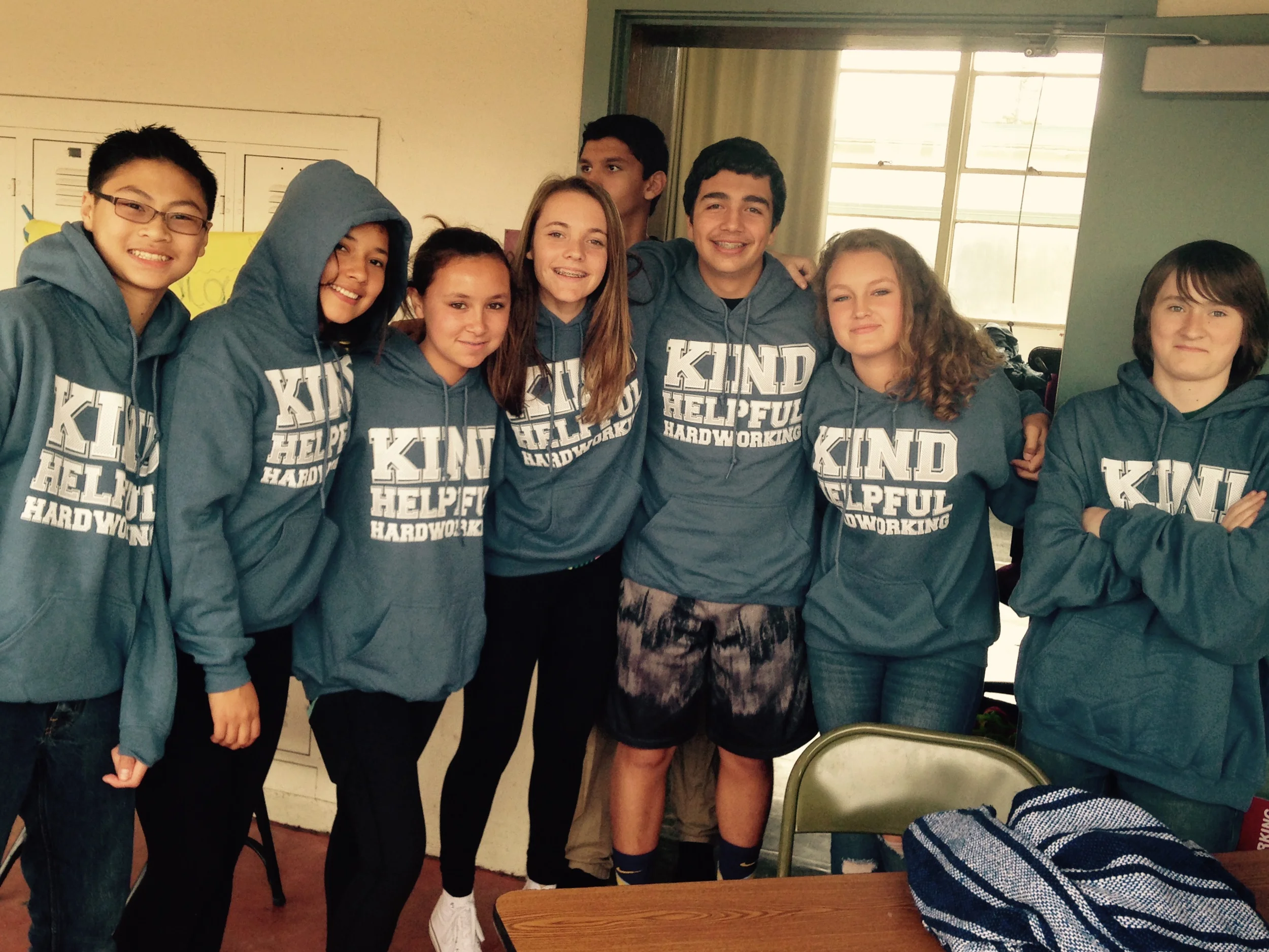 Students modeling their Kind, Helpful and Hardworking shirts to celebrate the school's Motto Weeks program