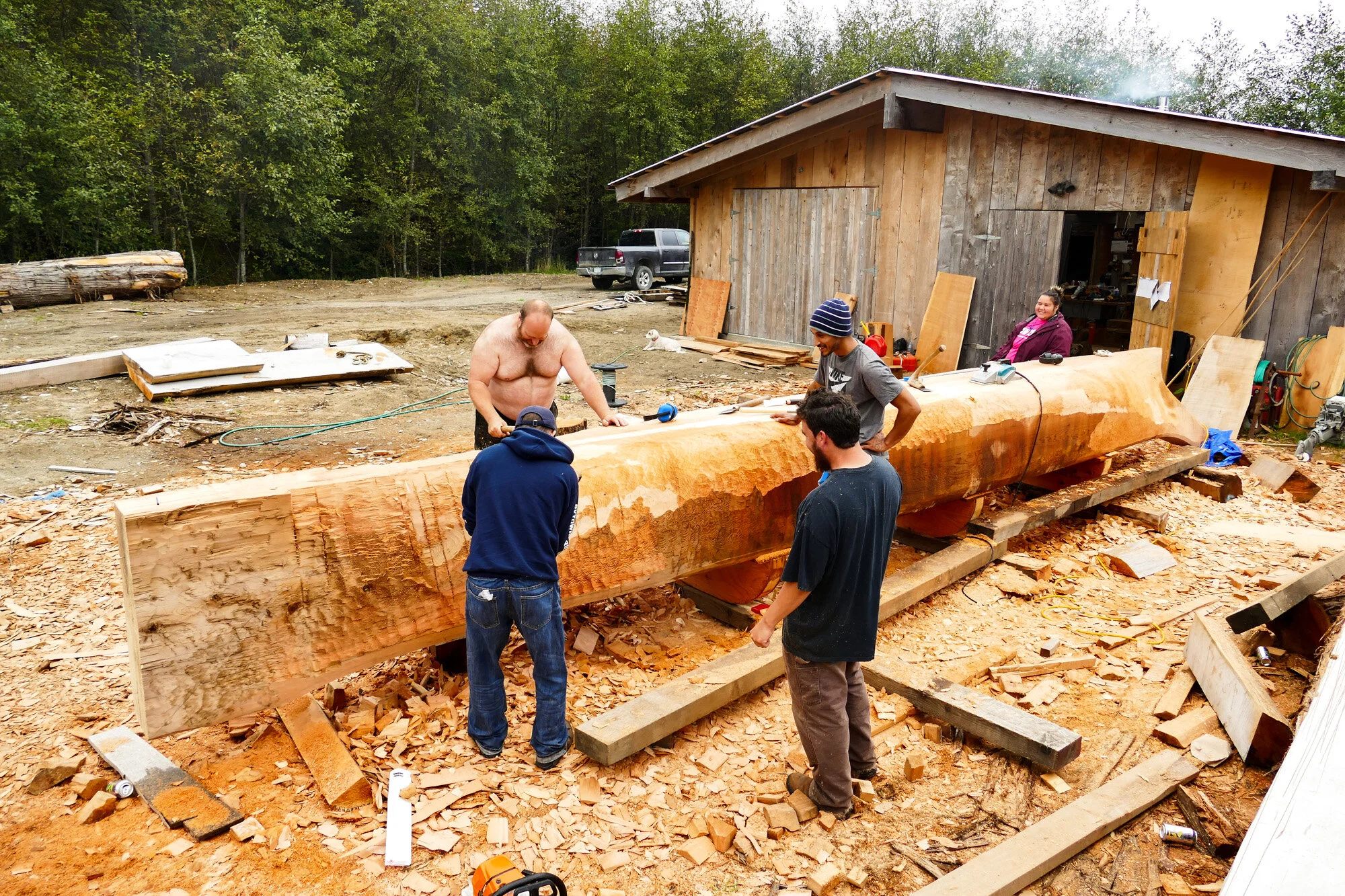 A look at the team working on the canoe, of Red Cedar, near Gaaw Kaahlii (Masset Inlet).