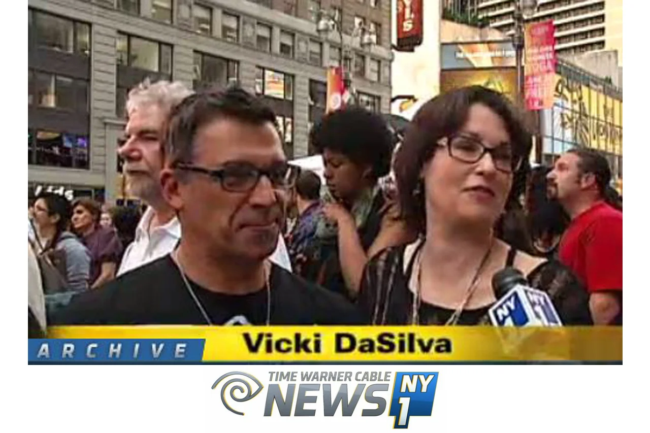 Art Contest Winner Gets Times Square "Screening" Time Warner Cable NY News 1 A new piece of art is now hanging in Times Square. The multimedia piece created by artist Vicki DaSilva hangs 23 stories above the famed "Crossroads of the World". The work features digital graffiti of the words "Never Sorry", written in homage to Chinese artist Ai Weiwei. watch video