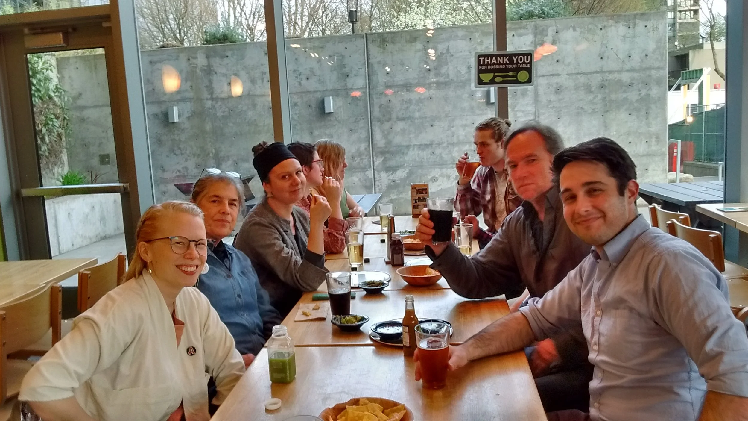 Your team (or most of them, if you look closely you can see Barry's fist behind Bill's beer) decompressing with drinks, guac and some GEU solidarity
