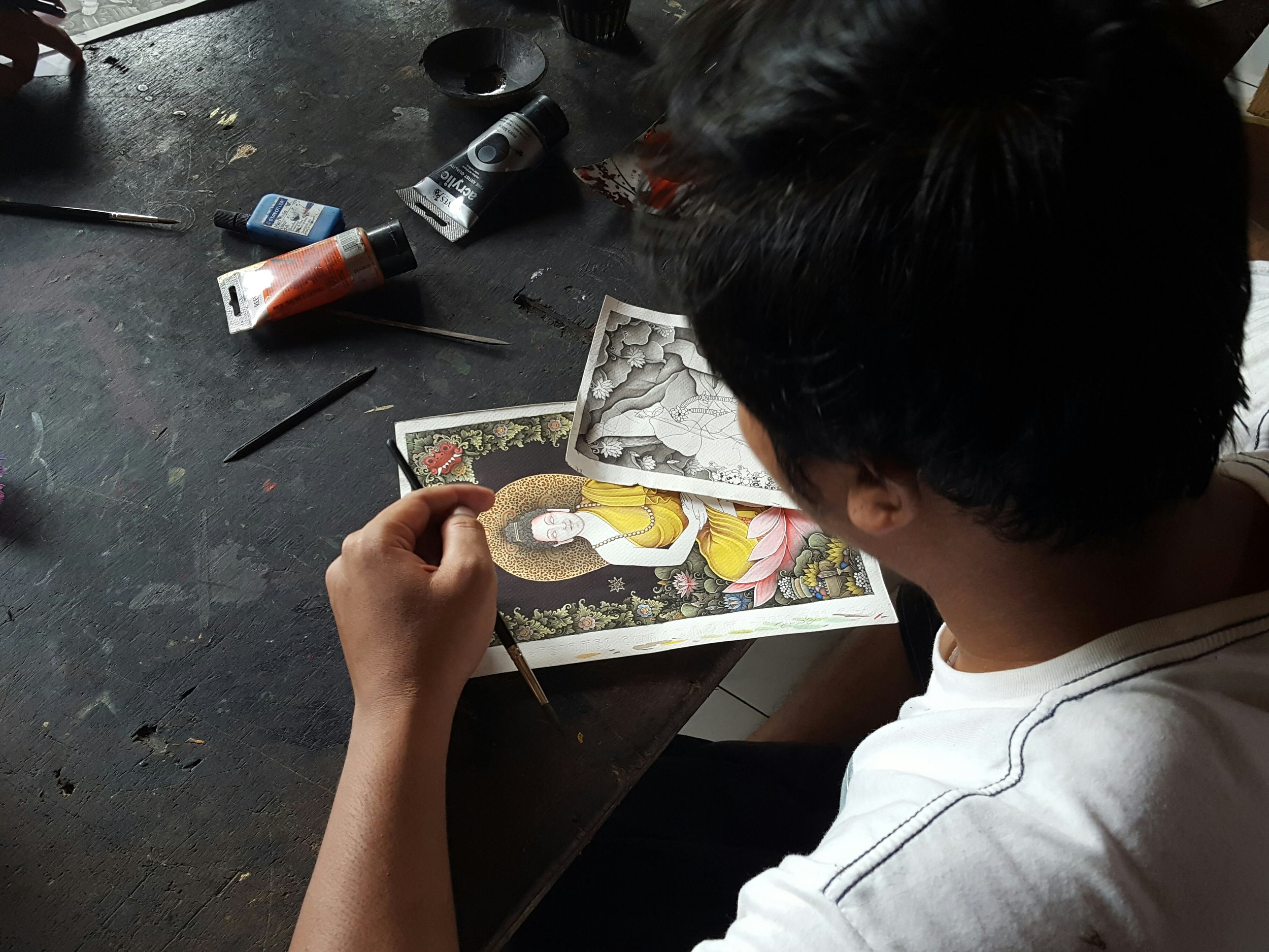 A young artist carefully adding the final touches.