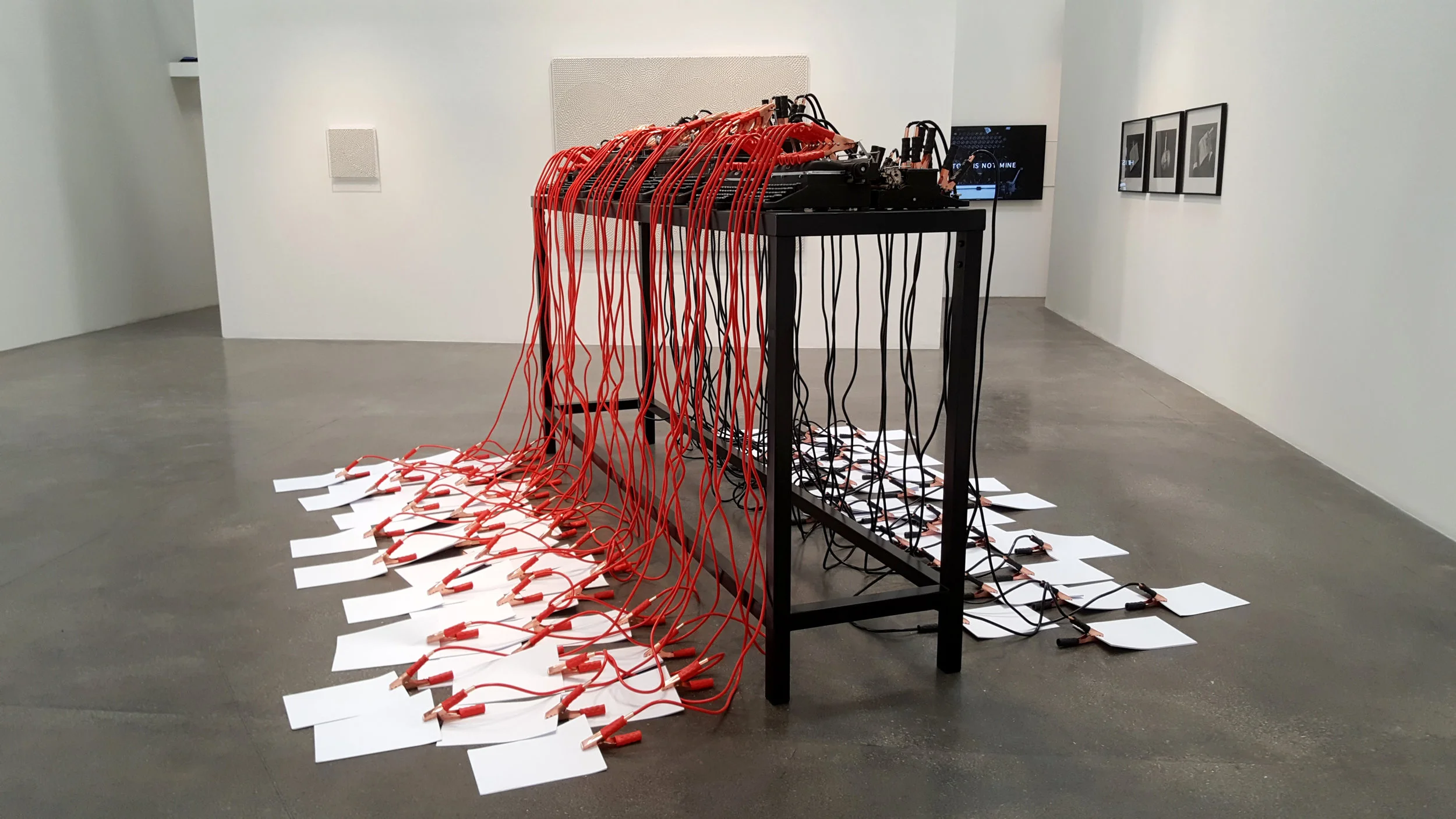 A series of vintage typewriters were hooked up to jumper leads and A4 paper.