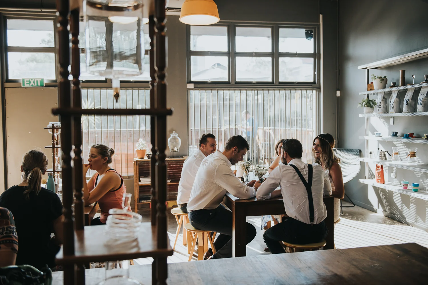 Bridal party bride groom relaxing in West End Brisbane cafe best wedding photographer Lightsmith Images