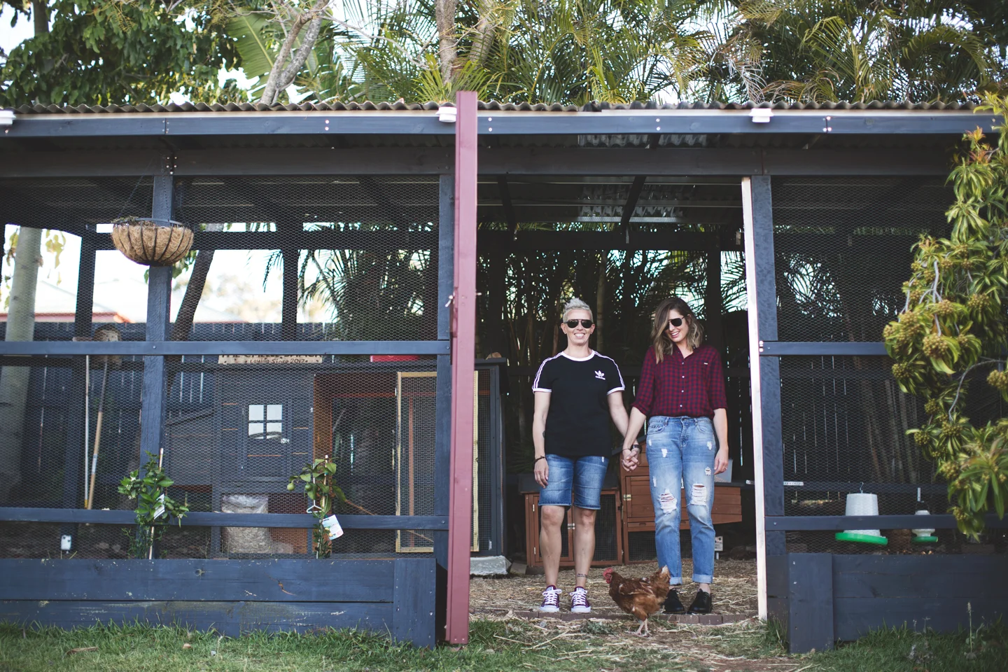 My wife and I standing in our chicken coop, while Dorothy plots her escape