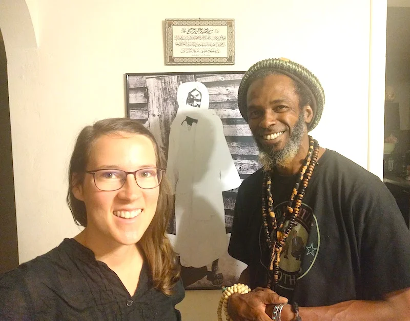 Khalifah and me in front of a photo of Cheikh Ahmadou Bamba, creator of the coffee blend.
