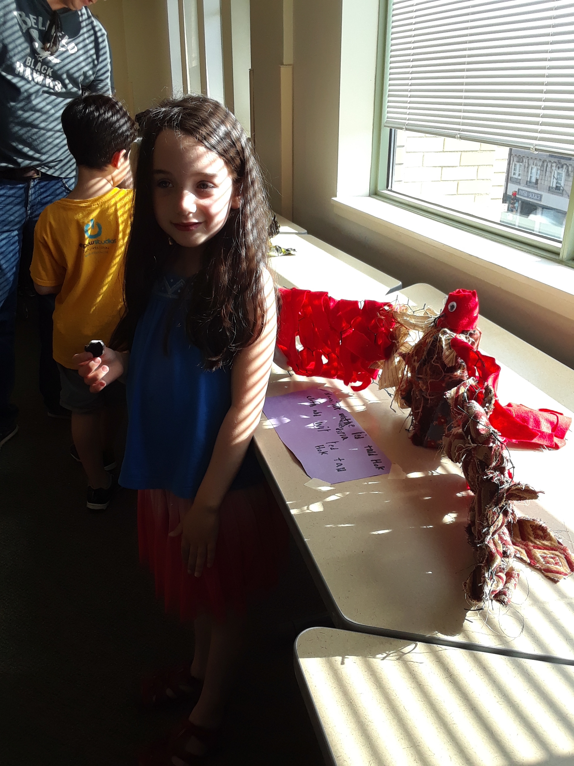 Student and her Red Tail Hawk sculpture 