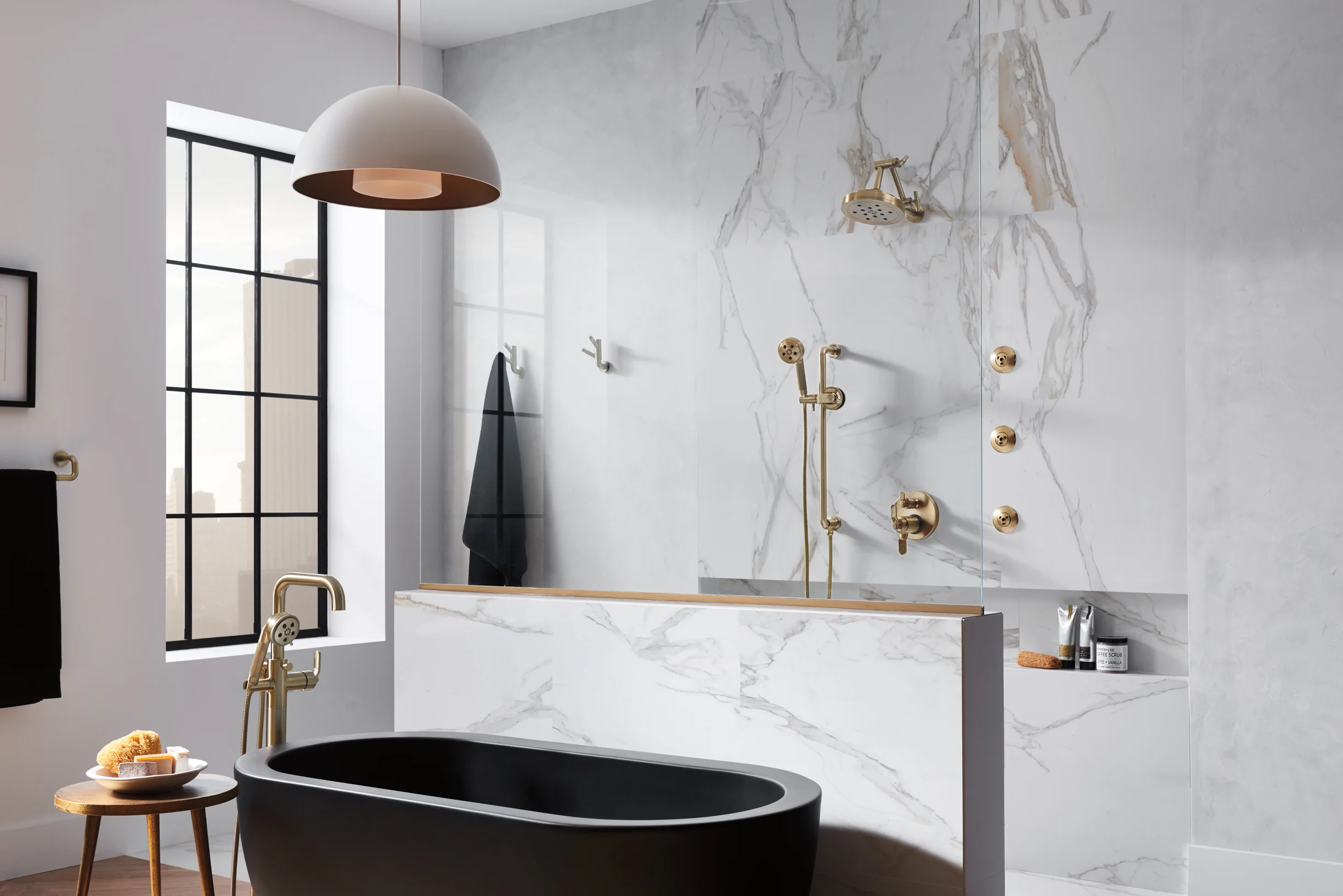 Brizo Litze collection minimal modern bathroom showroom interior with black tub and brass fixtures