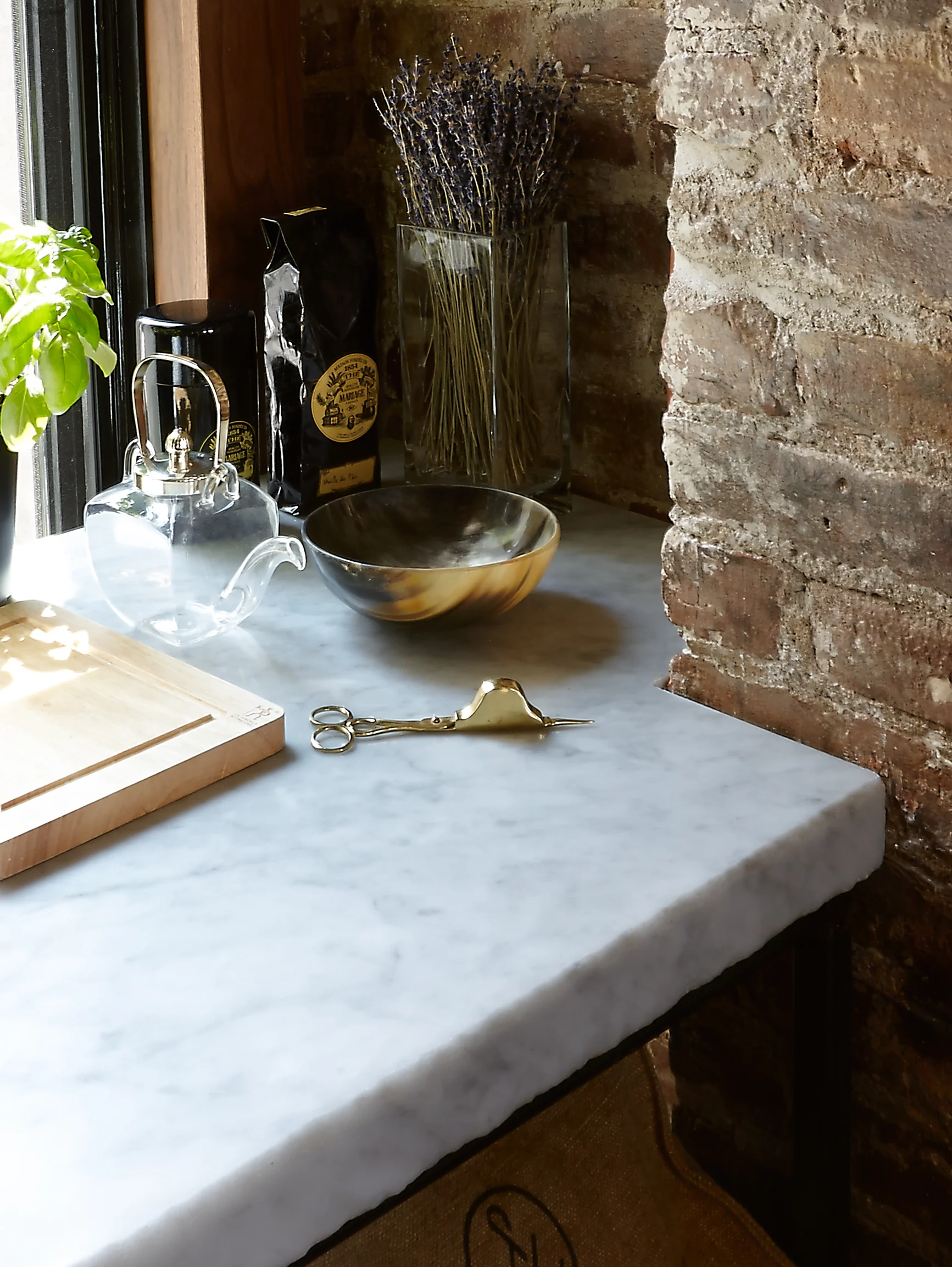 Modern New York apartment kitchen with marble slab and exposed brick