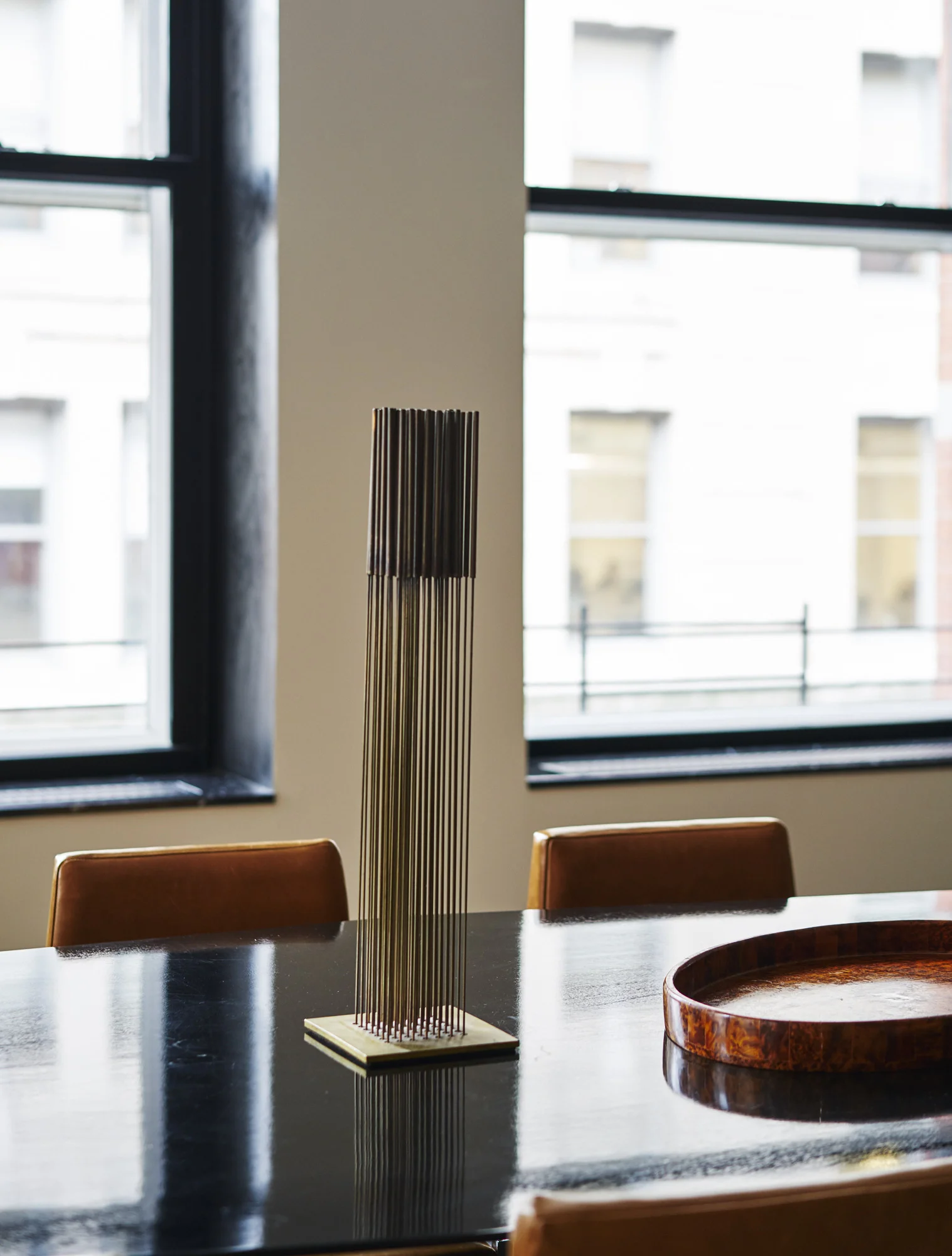 Modern Soho loft renovation dining room table and Bertoia sculpture