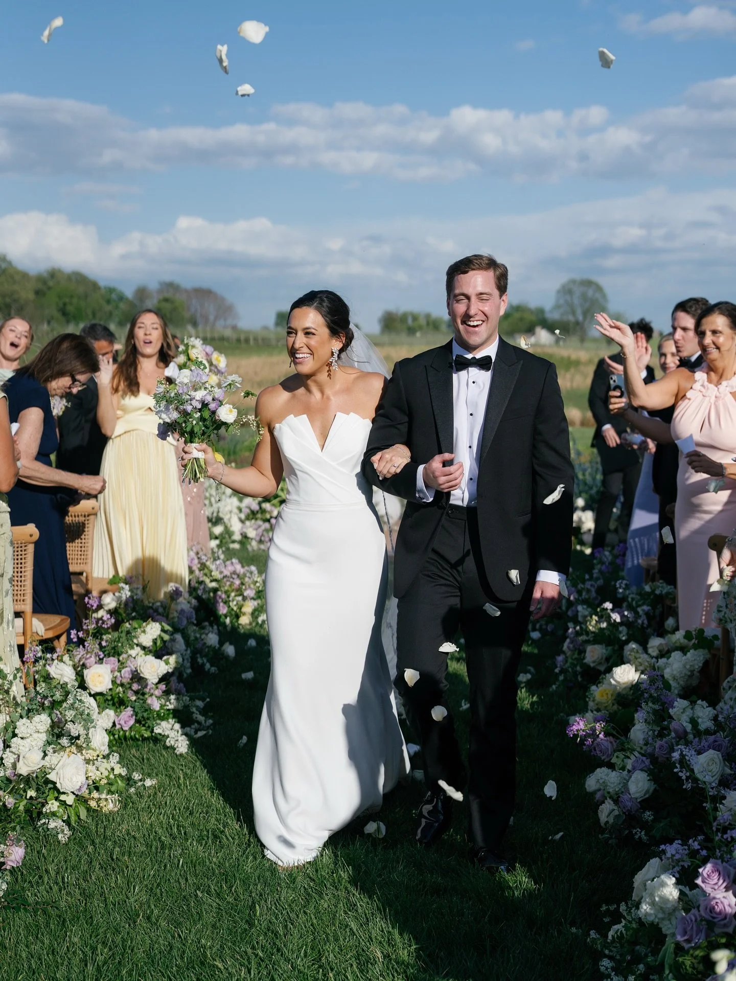 Still dreaming of Jessie &amp; Ryan&rsquo;s ceremony tucked into the hills of the Virginia countryside. Guests gathered in a soft semi-circle lined with wild florals, framing the couple in a way that felt intimate, intentional and completely transpor