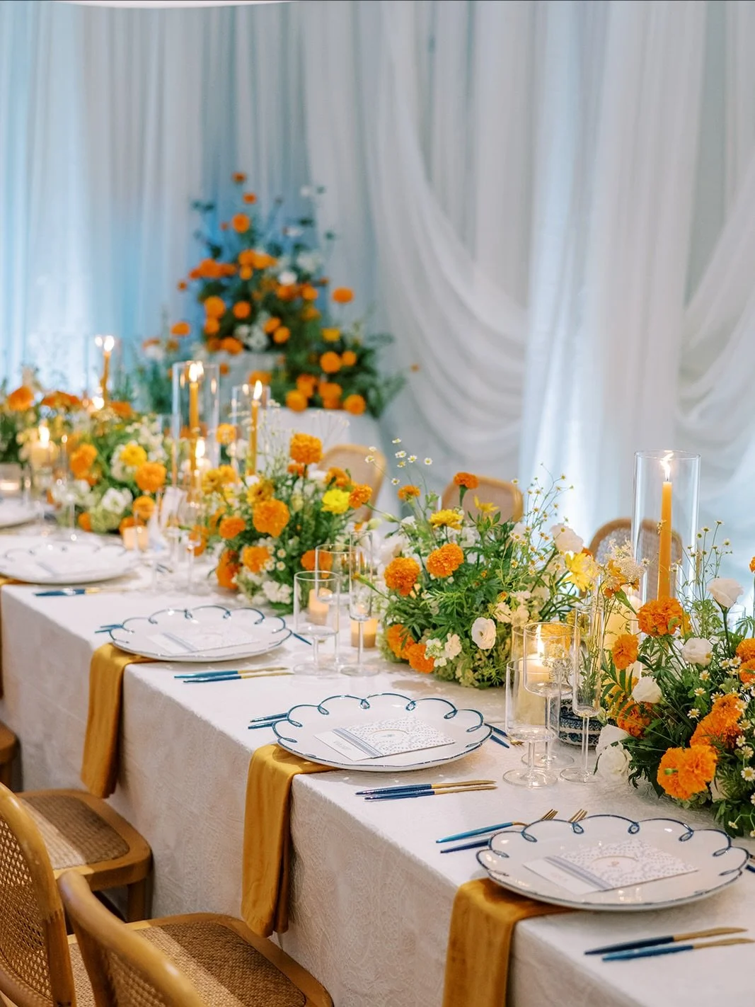 A gathering rooted in warmth, heritage, and intimacy. 
Cascading draping, marigolds, curated Bolesławiec patterns honoring the bride&rsquo;s Polish heritage, handwritten notes tucked into menus for each guest, and a candlelit glow designed for linger