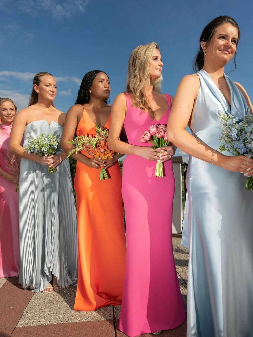 Cloud White could never.
Katie&rsquo;s bridal party served up a masterclass in vibrant color that we are all about this season: Sunset oranges, punchy pinks, soft blues, and golden pleats paired with monotype bouquets for a look that was curated, coh