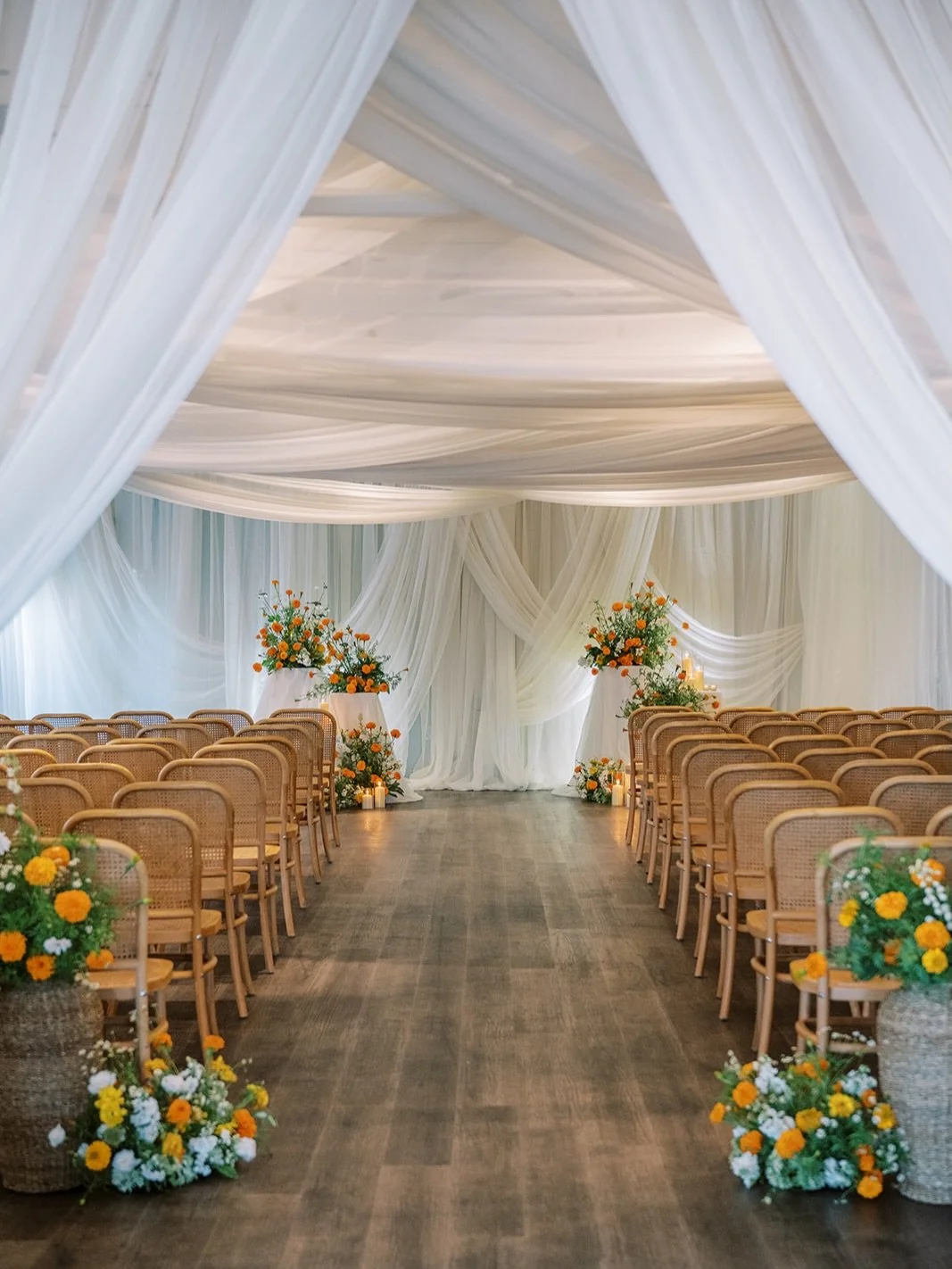 Marigolds in full bloom, a candlelit glow, and clouds of airy draping cascading overhead.

For Tola &amp; Alex&rsquo;s wedding, the atrium at @riggshotel was transformed into a setting that felt equal parts romantic, warm and luminous.

Photographer 