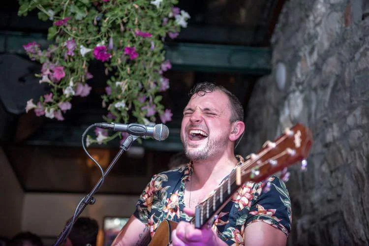 Matt Rowley on stage in Matt Molloy's yard bar