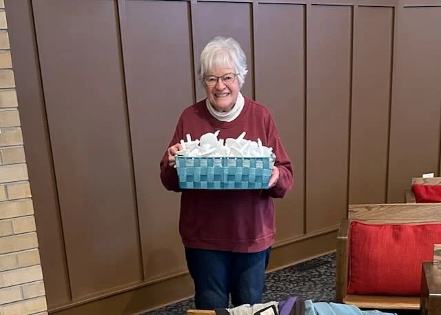 Kathy Wannamaker carries candles.jpeg