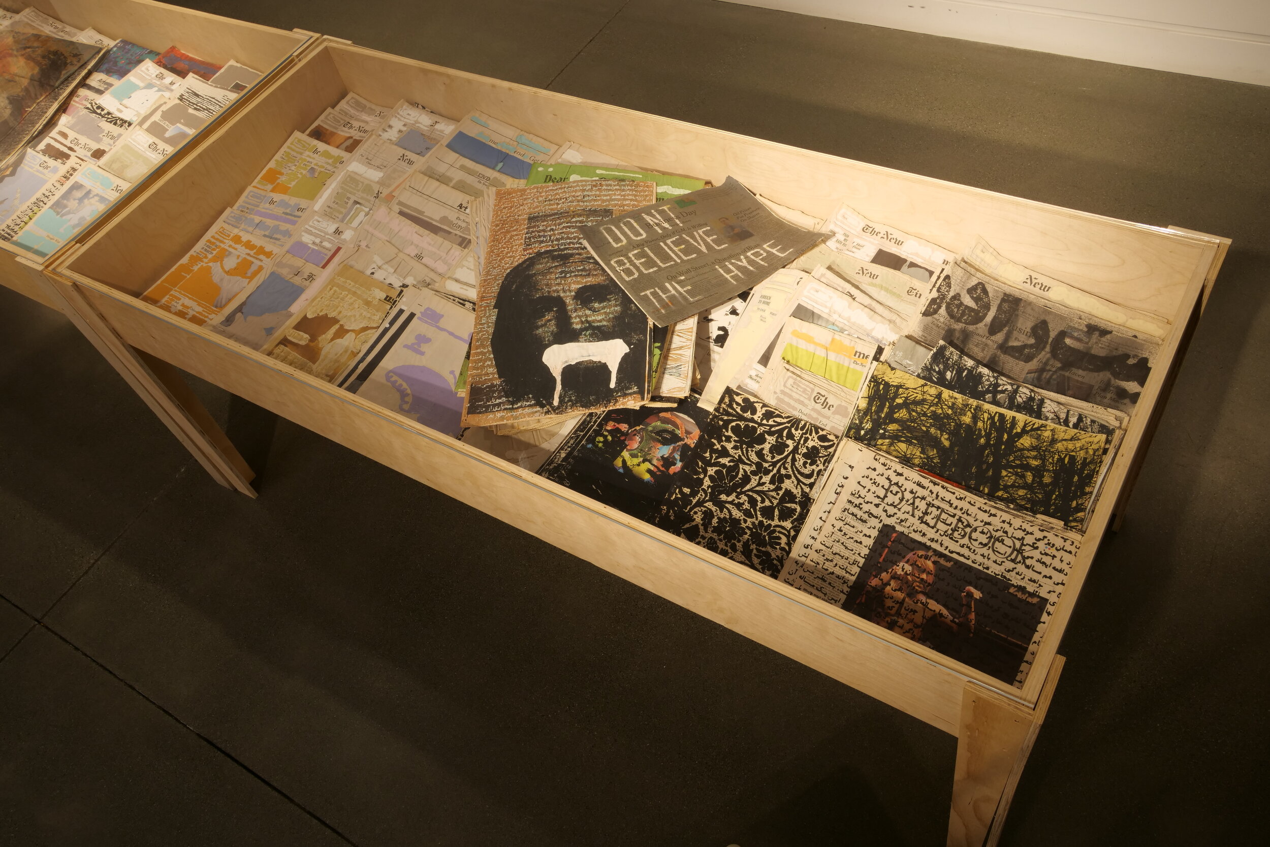 Display table featuring redacted magazines and media.