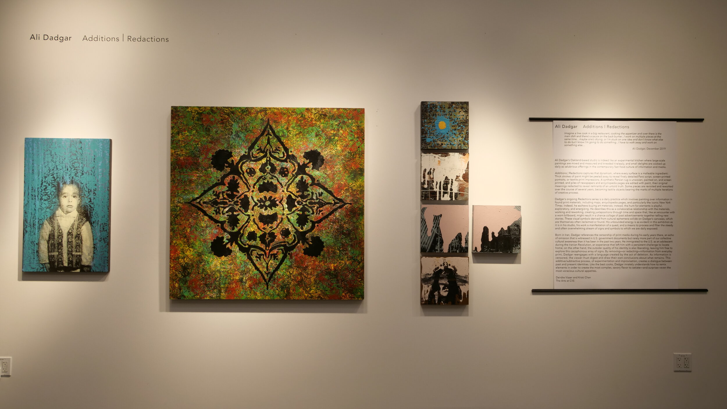 Display of paintings featuring a large square piece.  Black leaves and flourishes create a mandala like design on a mottled green and rust background. (Copy)