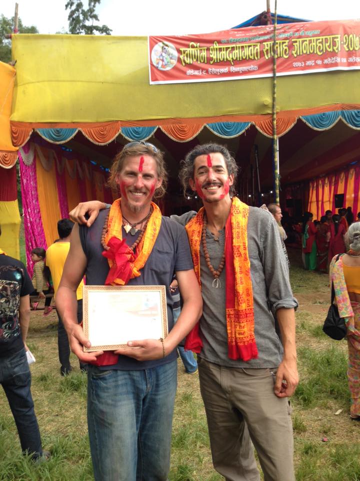 Cofounders, Allen and Orion, standing proudly with their "best dancing" award they received from a community celebration. 