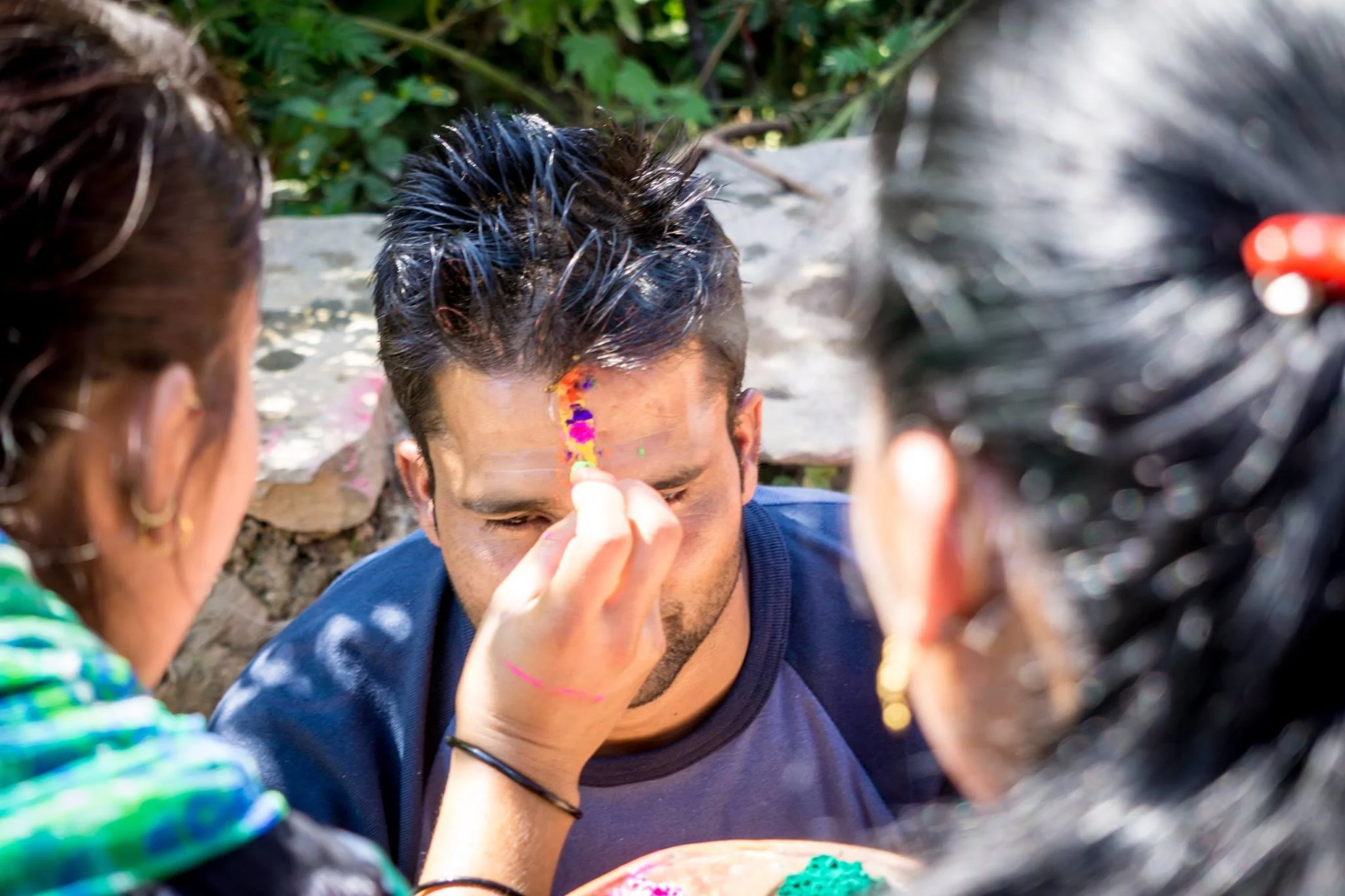 Uddhav, one of the local staff members at the Training Center, receives the special multi-colored tika from his sisters. Sisters give tika to their brothers to ensure long life and prosperity, as well as thank them for their protection. 
