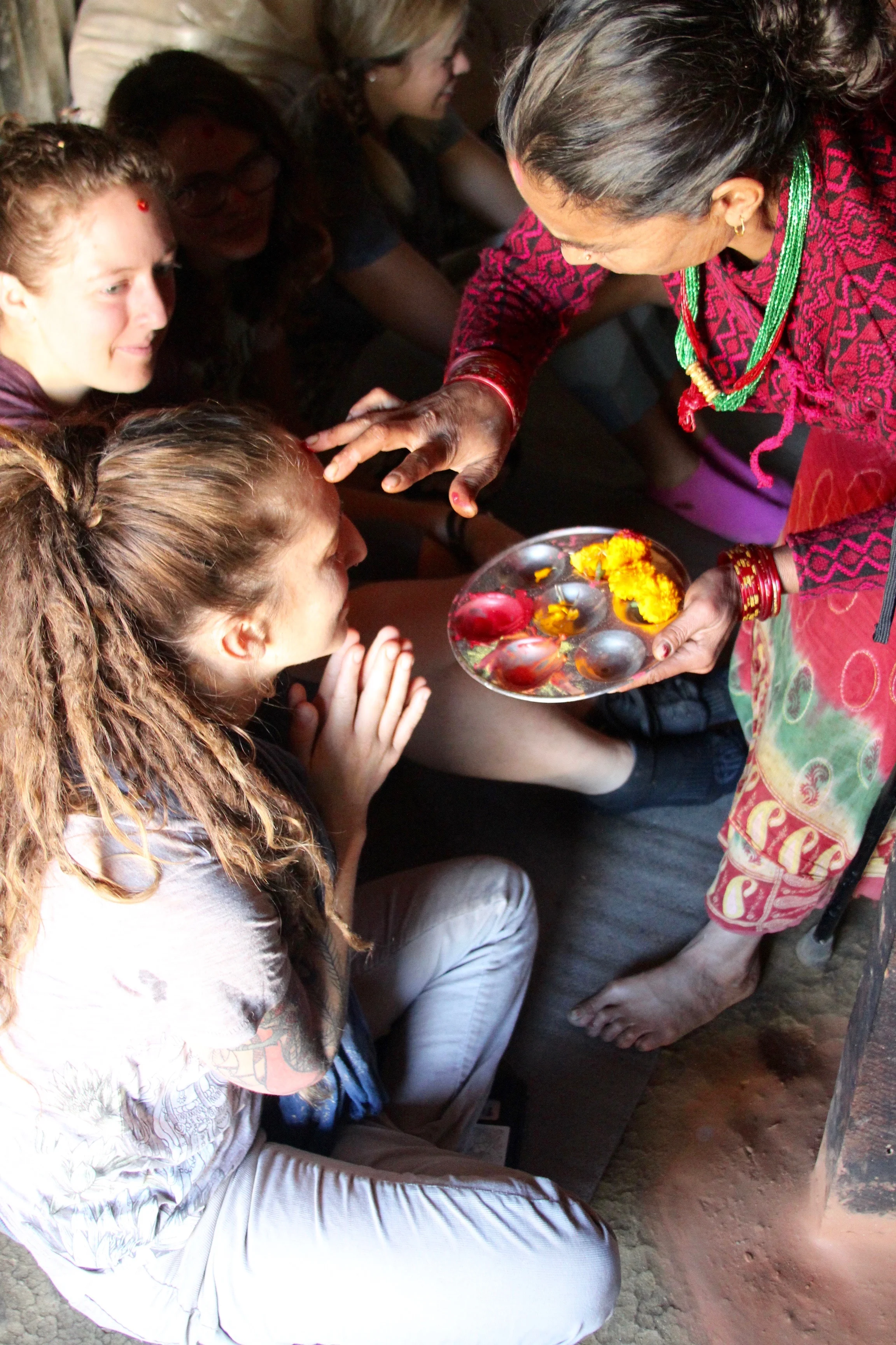 Dharma Shakti of Yogalution studio in Long Beach, CA receives tika or a blessing from a local community member in Takure. Starting each morning with meditation and chanting, visiting local temples, and participating in local traditions are all part of immersing ourselves in the practice of bhakti yoga. Bhakti yoga focuses on cultivating love and devotion. Practicing bahkti yoga allows us to better connect with the divine and our higher sense of self. 