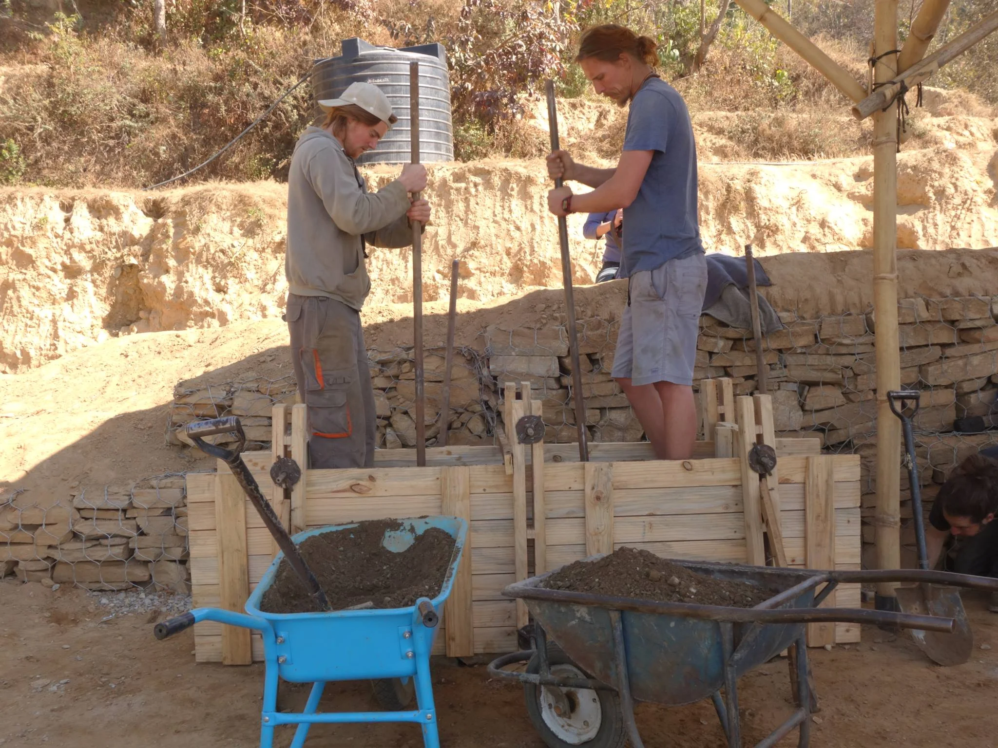 Allen and Maxime ram the walls inside the formwork for a test section.