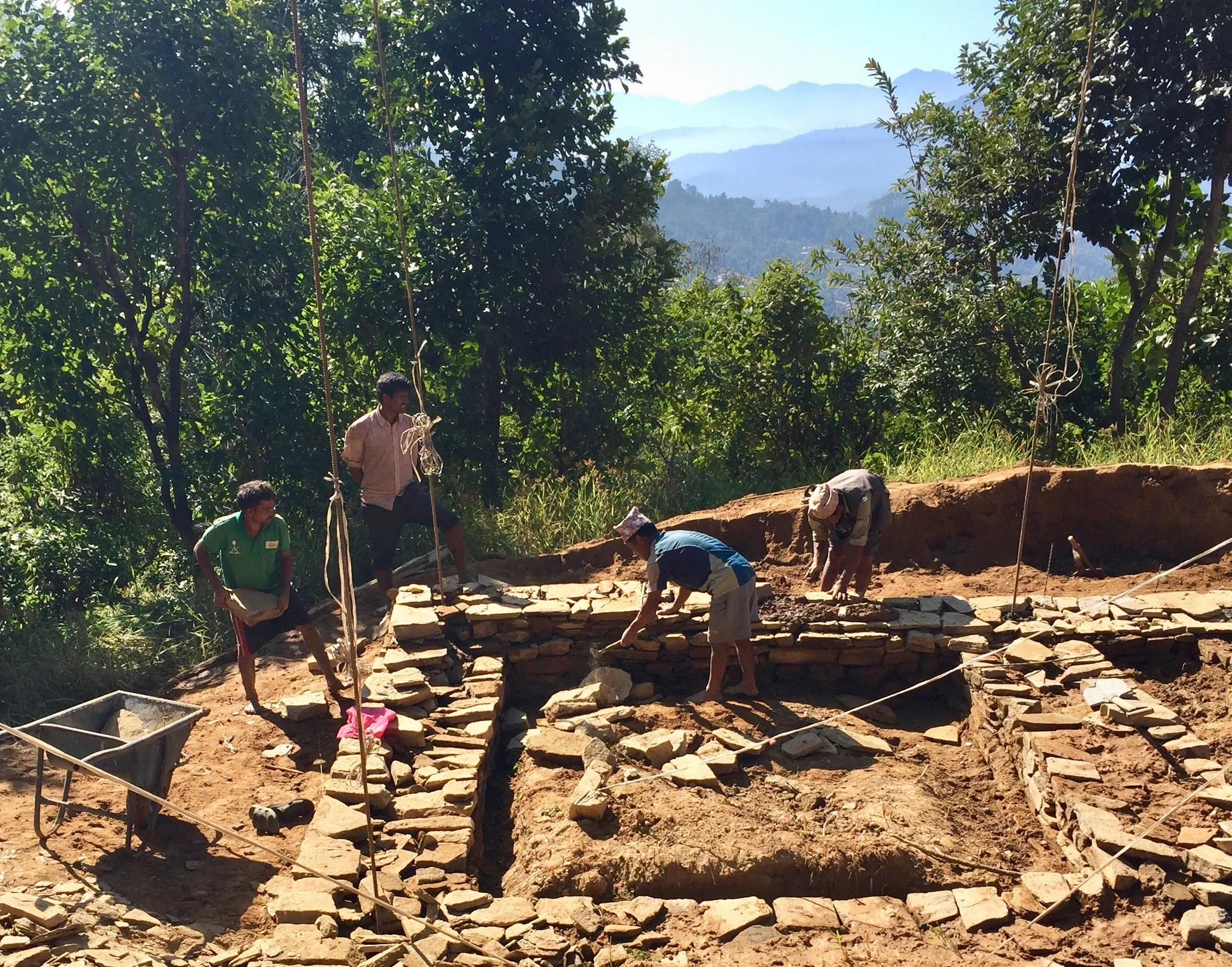 Photo 1: Krishna Kafle, our closest neighbor in Takure, nears the finish of his home’s foundation. Now he must decide which bricks to use to complete his walls and strive to finish his home before June. With support, he will rebuild his home with our CSEBs.