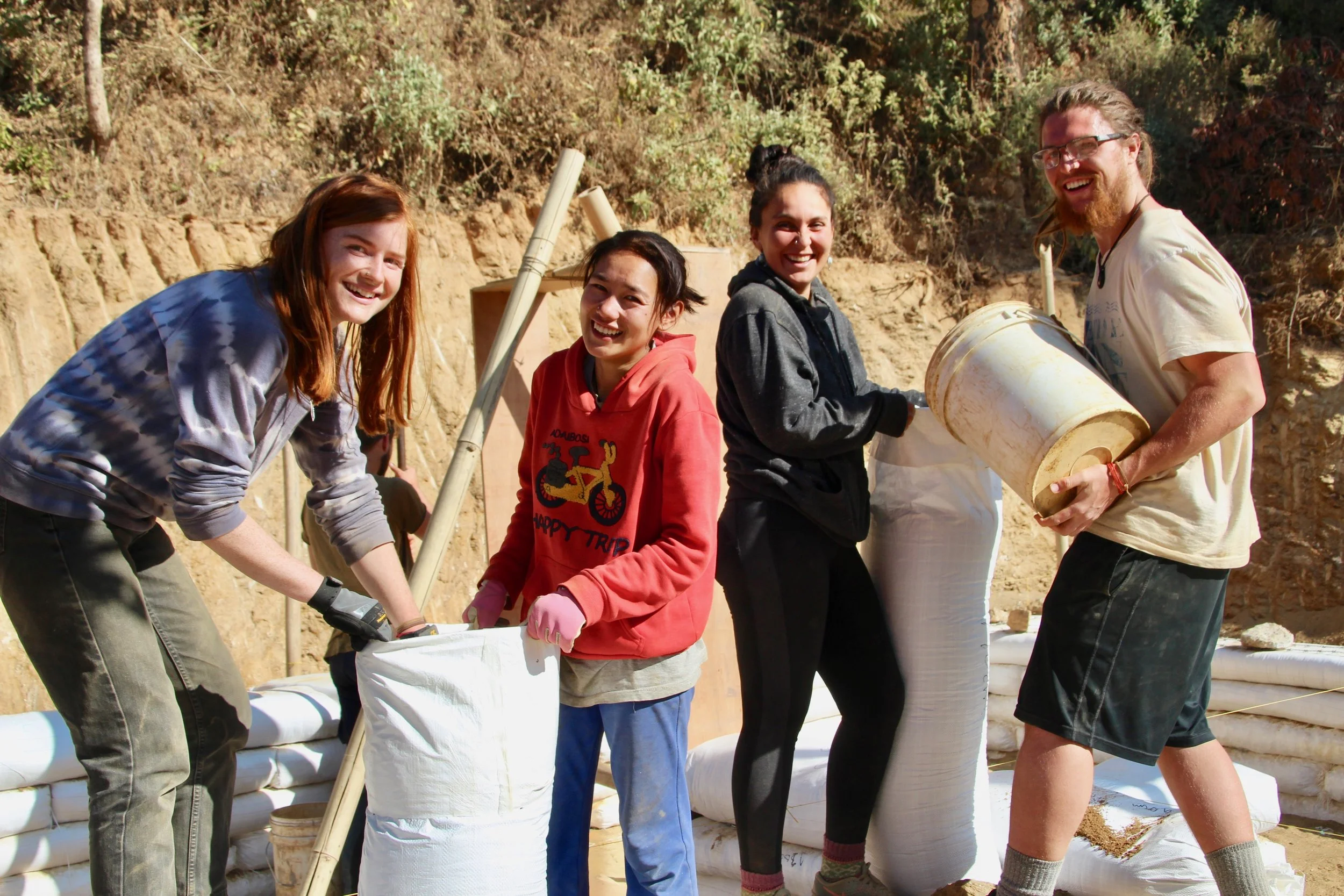 Conscious Impact volunteers filling earthbags during the construction of the new Takure Coffee Cooperative.