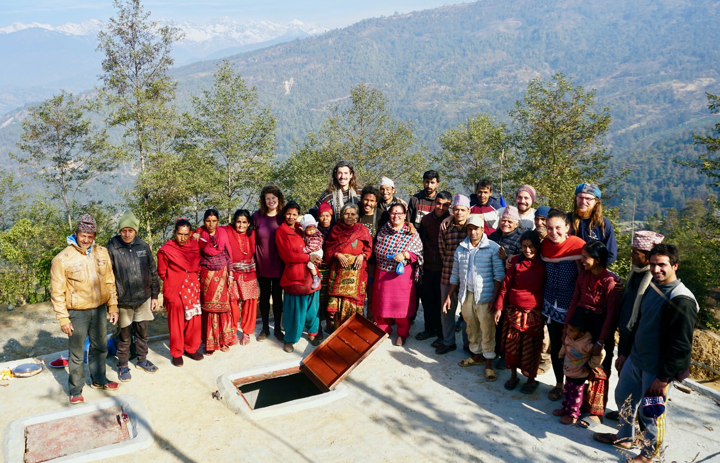 Community members and volunteers stand proudly on the new 40,000 liter water tank. Photo by Ankit Tanu