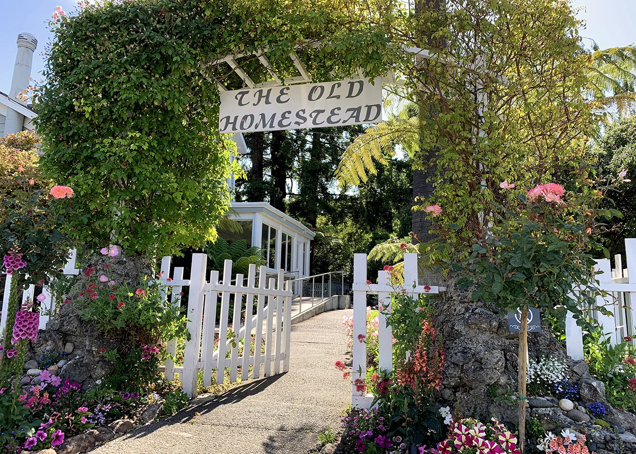 Exterior: picket fence and arbor entrance