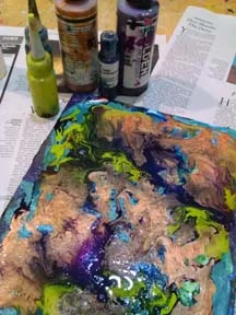 GOLDEN High Flow colors used for pouring include Anthraquinone Blue, Iridescent Copper, Permanent Violet, and a mix of Green Gold with Hansa Yellow Light.