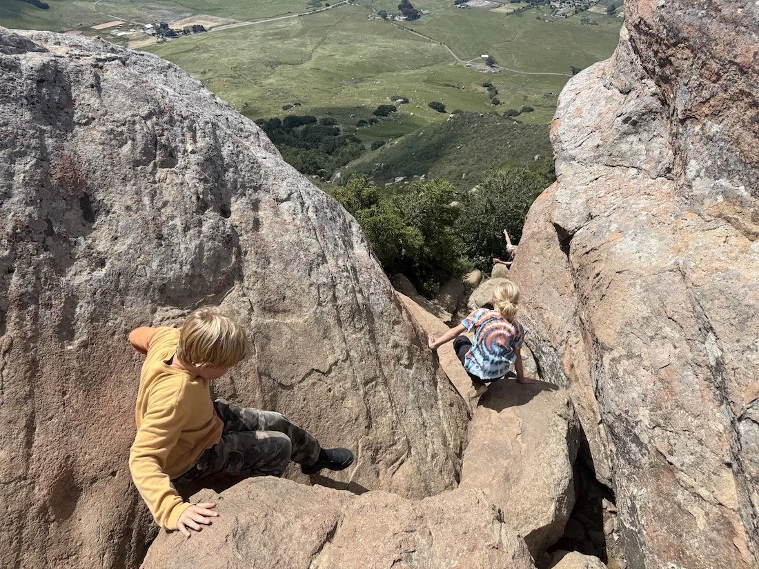 NE kids climbing down rocks.jpeg