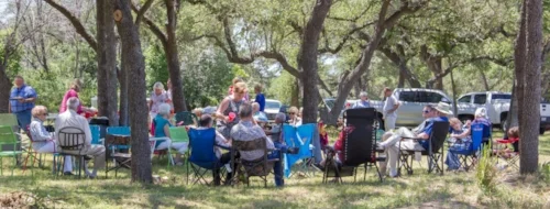 Shade trees along the blanco river create a pleasant atmosphere for a spring picnic