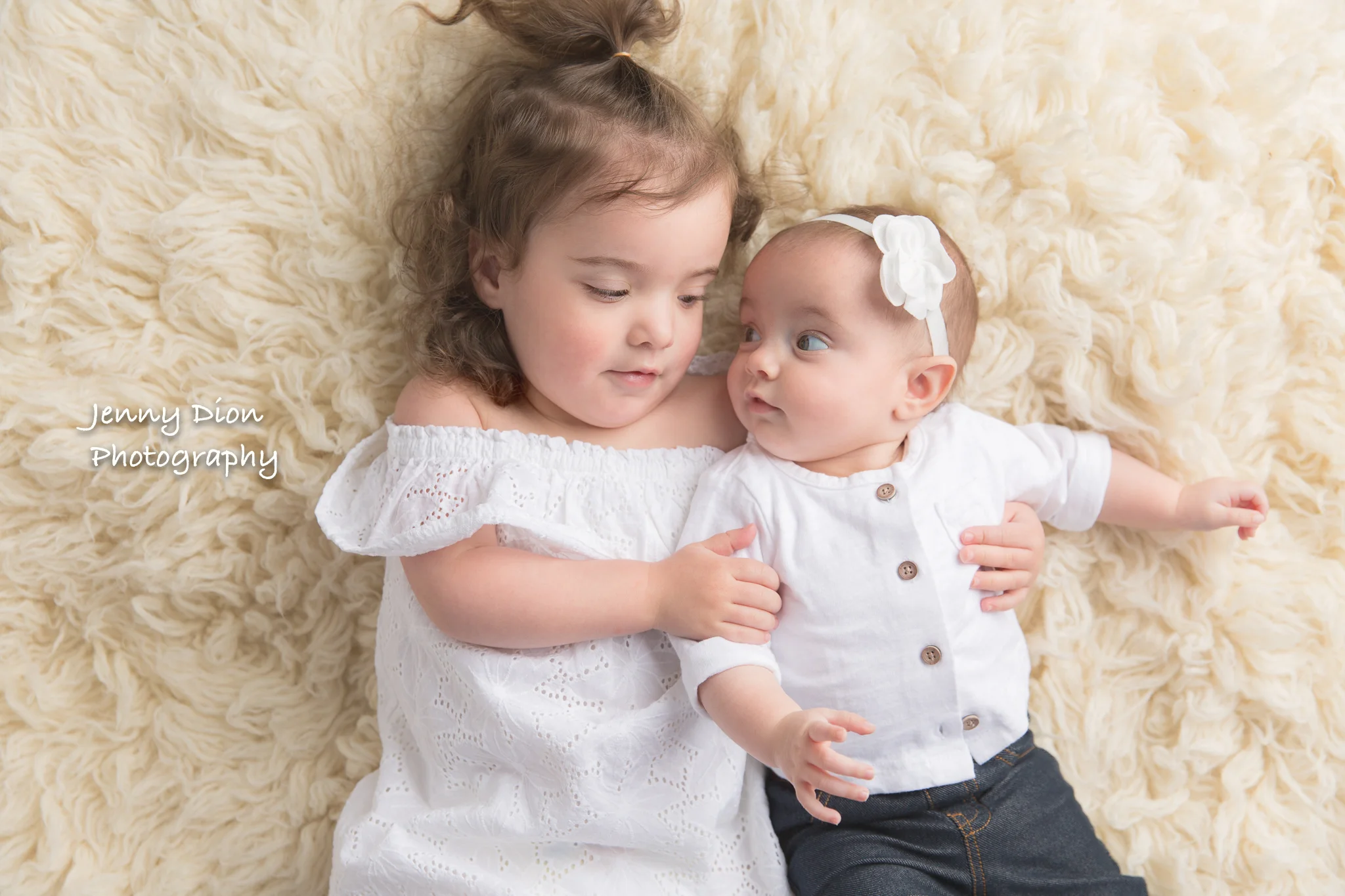With her baby sister.