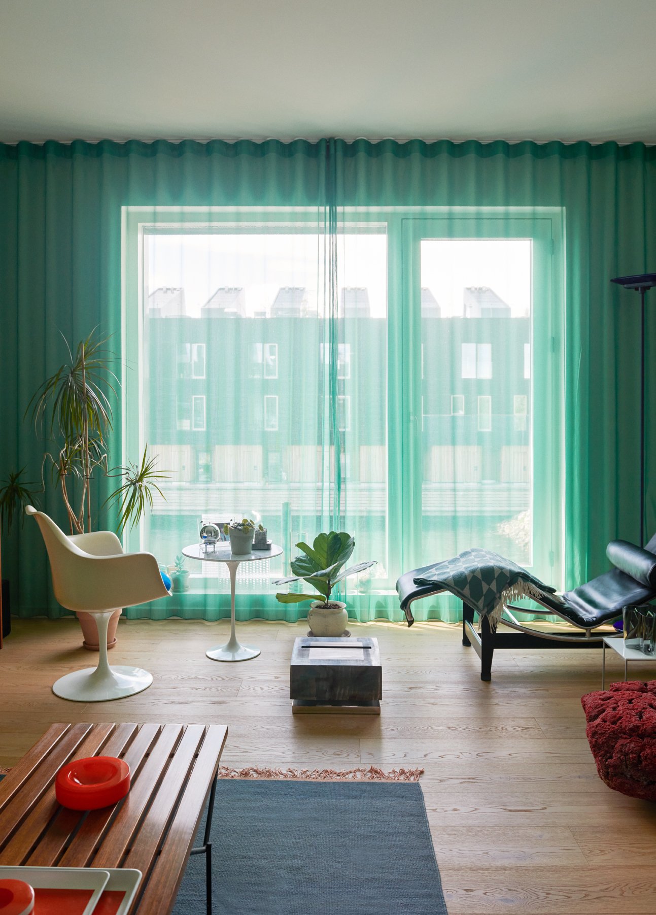  In the living room, vintage seating and side tables by Eero Saarinen, Le Corbusier &amp; Charlotte Perriand, and Poul Kjærholm flank a lamp from Denys’ ‘SelfReflect’ collection     