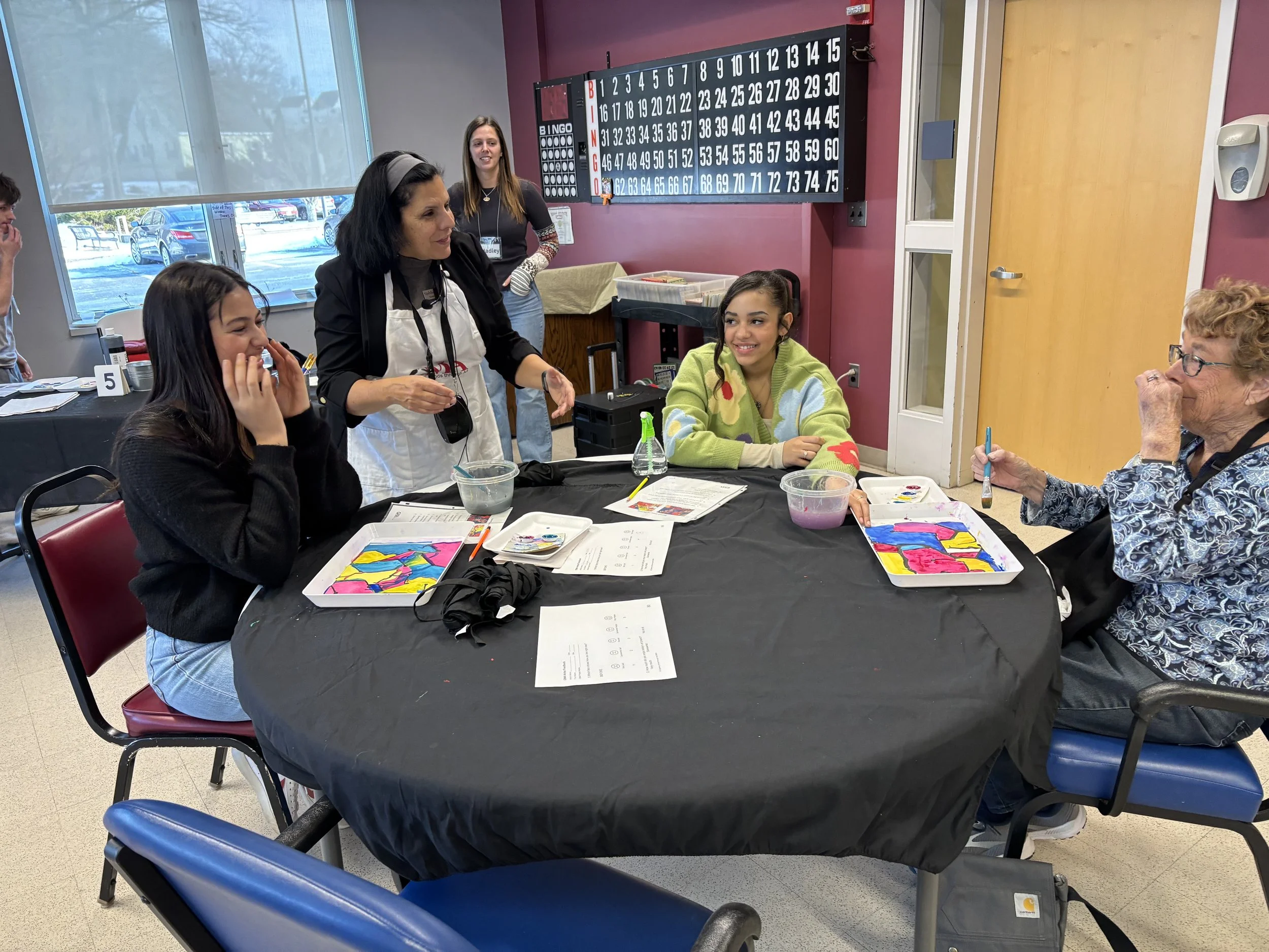 Chatting with some volunteers and an artist.