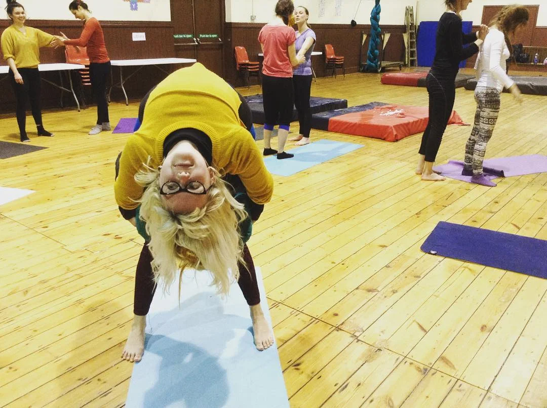 One or two people? Liing enjoying an upside-down stretch after class.