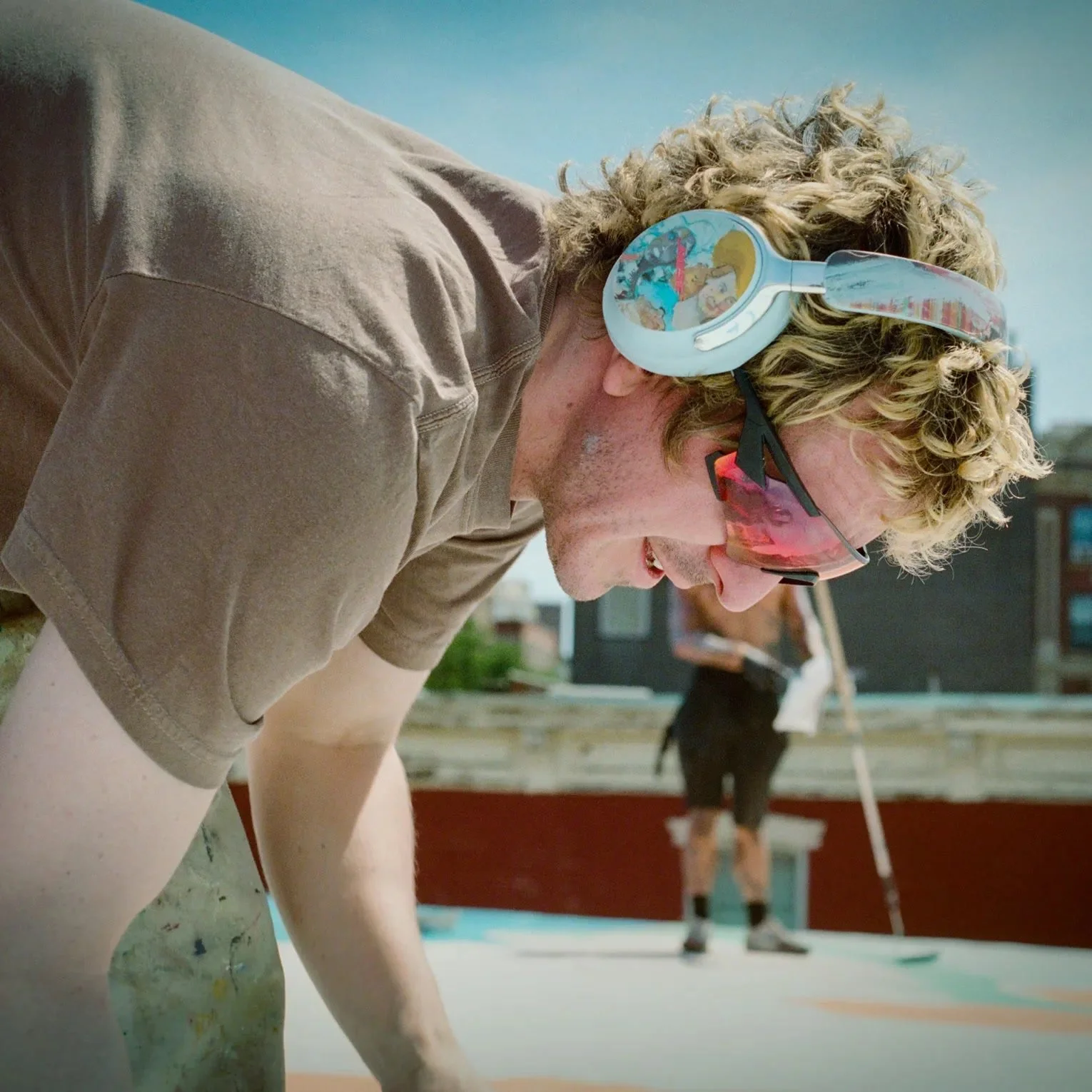 Bose x KidSuper campaign — artist wearing hand-painted QuietComfort Ultra Headphones, Moonstone Blue