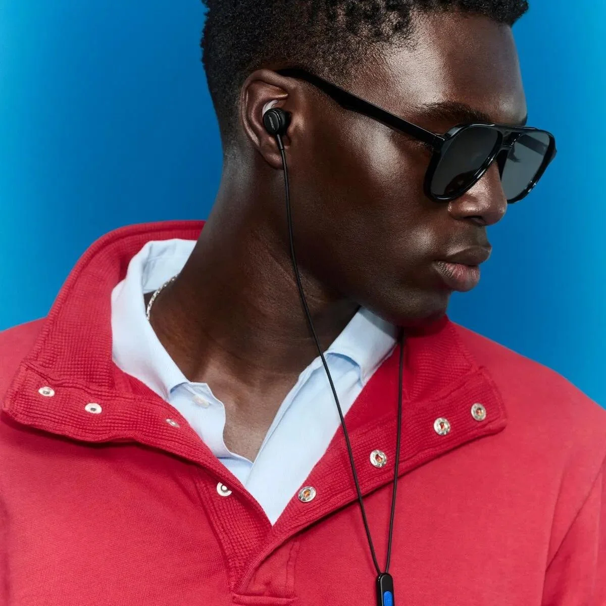 Bose Noise Cancelling Wired Earbuds lifestyle — man wearing the wired earbuds outdoors