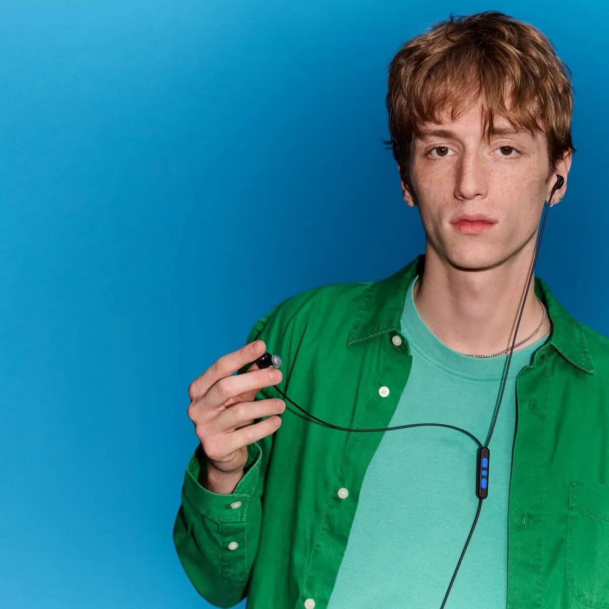 Bose Noise Cancelling Wired Earbuds lifestyle — young man wearing earbuds