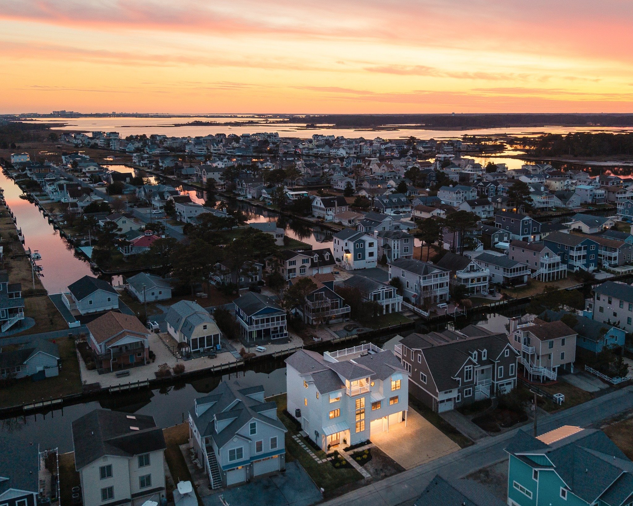 There&rsquo;s nothing like twilight along the coast.
From above, you can see what makes this community special&mdash;homes, shoreline, and both the ocean and bay coming together. Our FAA-certified drone team captures these views safely, beautifully, 