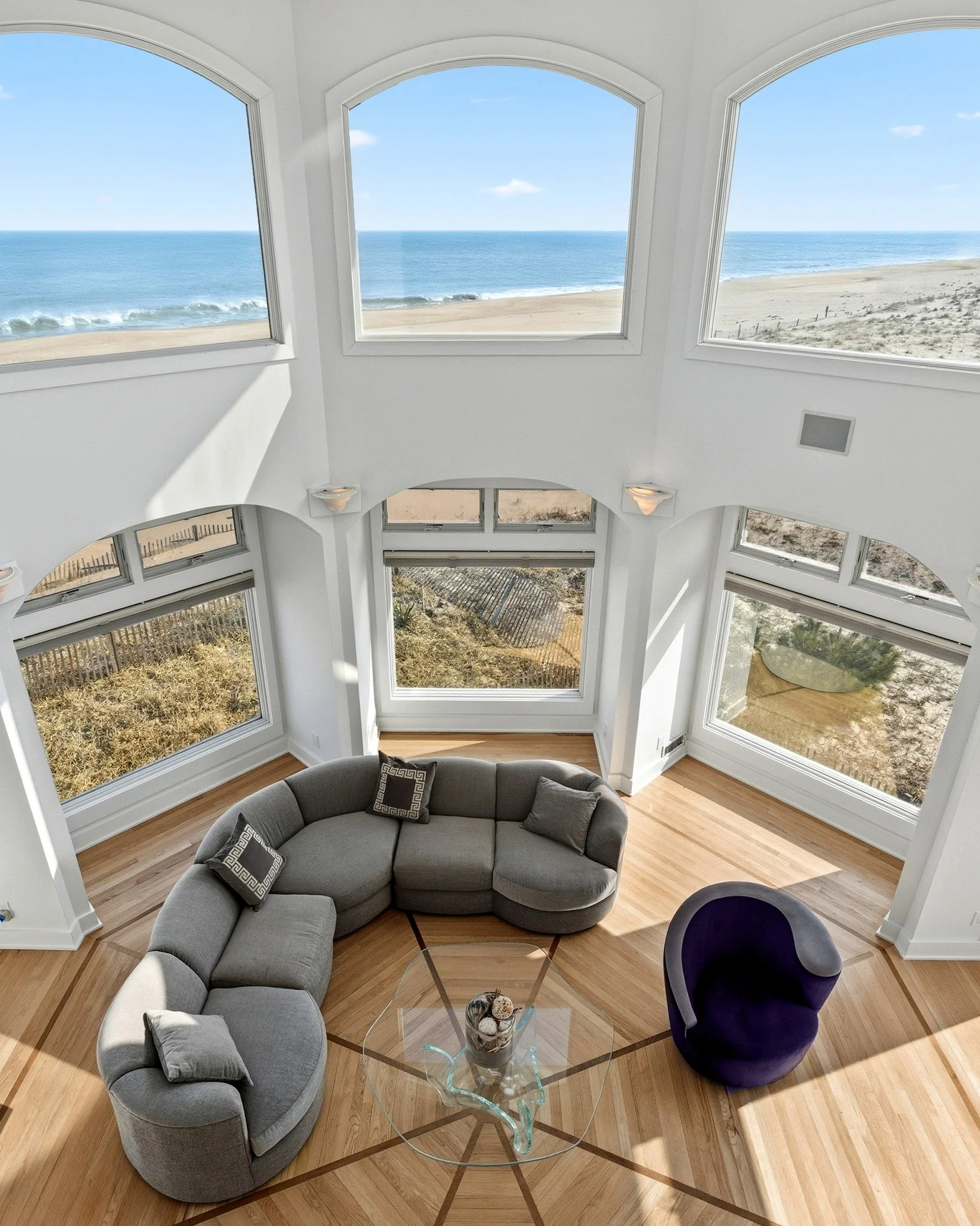 Some views are meant to be experienced from every angle.
From below, the soaring windows draw your eye upward &mdash; natural light filling the living room and the balcony above creating a sense of scale and openness.
From above, the perspective shif